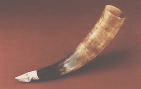 Medieval baby bottle made from animal horn, with a perforated leather teat.
